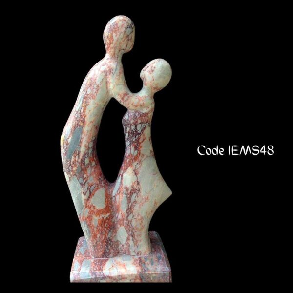 Modern abstract marble sculpture is of a couple in romance is in onyx Marble